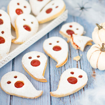 Ghost-shaped shortbread cookies with strawberry jam &ndash; Halloween treats