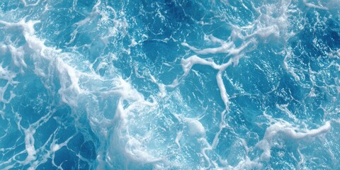 Obraz premium Bright turquoise ocean surface shows swirling white foam from turbulent water movement