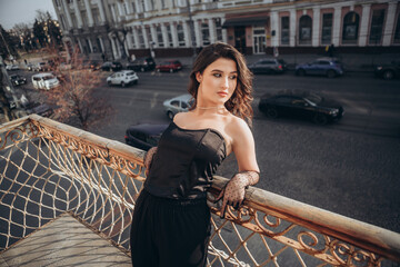Elegant woman on balcony against urban landscape