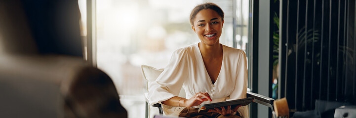 A joyful and enthusiastic woman actively engages with her colleagues in a bright, contemporary...