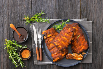 bbq baby pork ribs with fresh rosemary on a plate