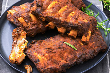 bbq baby pork ribs with fresh rosemary on a plate