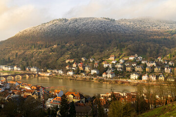 Picturesque European Riverside Town with Historic Bridge and Hillside Houses in Warm Light
