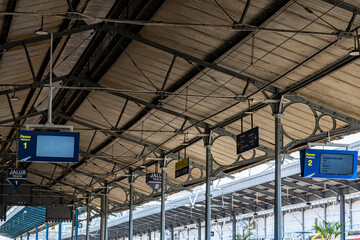 Modern Train Station Platforms with Steel Roof and Digital Information Boards