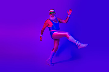 Fototapeta premium Senior fitness icon in retro athletic wear leaps in a neon blue and purple studio for an energetic lifestyle and wellness advertising vibe