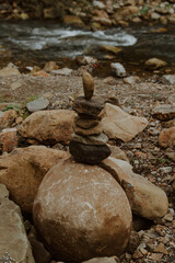 Balancing stone tower by mountain river, concept of relaxation and meditation