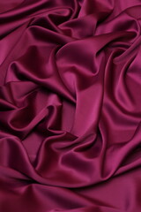 Vertical close-up of luxurious fuchsia pink acetate satin fabric, heavily draped and folded to showcase its silky texture, rich luster, and flowing nature, ideal for fashion and elegant apparel design