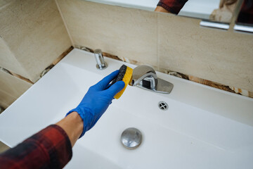 cleaning sink with scrubber and gloves, thorough bathroom sink cleaning with glove and scrubber