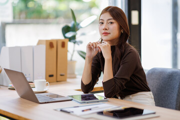 Concerned puzzled asian freelance worker woman looking at laptop with confused hand gesture....