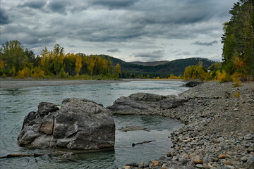 Russia. The South of Western Siberia, the Altai Mountains. Picturesque view of the rocky shore of the Katun River in autumn colors near the village of Manzherok.