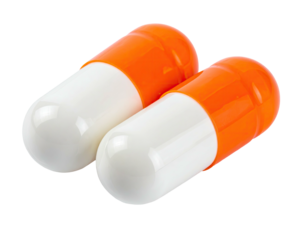 Two large capsules with white and orange segments, isolated on a black background