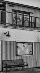 Modern Metal Building with Wall Lamps and Metal Benches in Black and White.