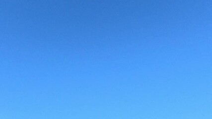 Small handmade model airplane soars smoothly through bright blue sky with wings gliding under sunlight representing freedom creativity and childhood imagination