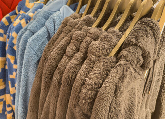 Fluffy soft teddy fleece jackets on a clothes rack in a department store 
