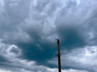 Utility Pole and Power Lines Against a Stormy Sky