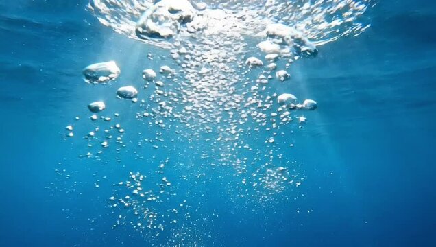 Underwater bubbles rising to surface stock footage deep blue ocean sea water background video clip