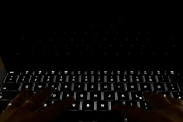 hands typing on a keyboard