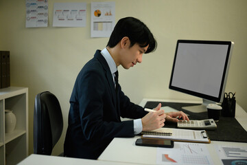Professional Accountant Working on Financial Audit Report at Desk
