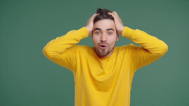 Handsome Man Reacts With Amazed Expression, Says Wow, Open Mouth, Holding Head
