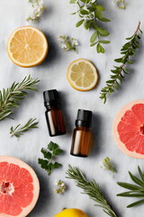 Essential oils and sliced fruits arranged on linen  surface