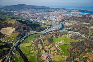 The aerial view captures the beautiful landscapes around Peage Biriatou and Hendaye, featuring lush greenery, winding rivers, and a coastal town under a clear blue sky.