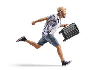 Male tourist holding a suitcase and running
