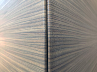 Close-up of a wooden corner with natural texture and grain pattern, showing precise panel alignment and smooth finish.
