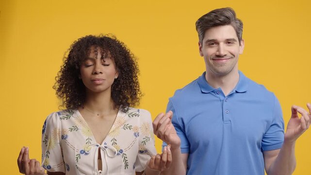 Calm Diverse Couple Relaxing, Meditating, Refuses Stress. Man And Woman Breathes