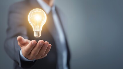 Innovation and creativity concept: Man presenting new idea lightbulb with text area