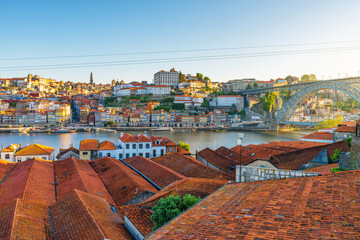 Panoramic view of Porto city Ribeira district with red rooftops, Douro River and Dom Luis Bridge at...