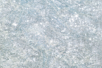 The background of the fabric is decorated with a scattering of silver sequins creating an abstract shimmer.