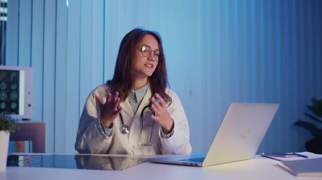 Mental Health Support. Psychologist or Doctor in White Coat Conducts Online Therapy in Evening, Offering Guidance and Emotional Healthcare Through Video Call