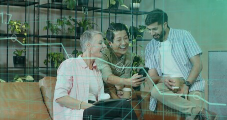 Collaborating coworkers reviewing smartphone graph in office lounge holding coffee cups, tablet