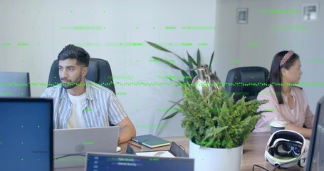Typing coworker with laptop and colleague holding coffee cup gazing right in office with VR headset