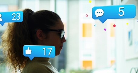 Monitoring woman with glasses turtleneck sitting in office, with notification icons, copy space
