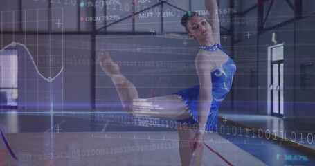 Balancing teenage gymnast wearing blue leotard doing leg extension on mat in gym, with ribbon stick