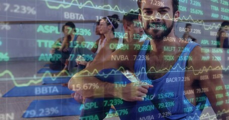 Twisting man on yoga mat in studio with mirror reflection, financial charts overlay, copy space
