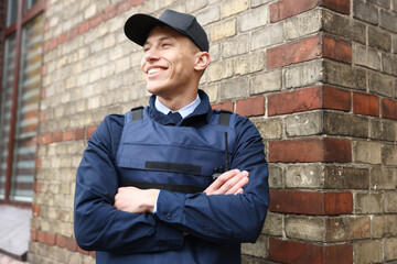 Portrait of smiling police officer on city street