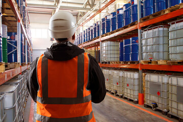 Warehouse inspector monitors chemical storage, ensuring safety compliance and proper handling of...