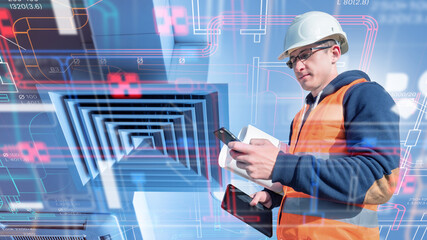 Construction engineer checks HVAC digital schematics on site using tablet and smartphone, ensuring ventilation system installation and technical accuracy.