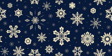 Christmas seamless pattern snowflakes on deep blue indigo background. New year holiday gold ice crystals glowing in night sky. Winter half drop repeat design for textile fabric, wrapping paper print.