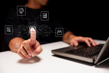 A person interacts with digital icons on a touch interface, symbolizing technology and data management, in a dark, modern setting.