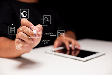 A person interacts with digital icons on a tablet, illustrating technology and innovation in a modern workspace.