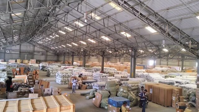 Timelapse of busy warehouse for export import goods. Workers operating forklift and sorting packages top view. 
