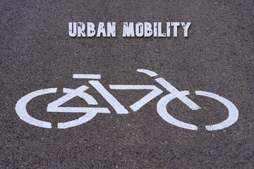 urban mobility concept. words written on the asphalt on the icon of a bike lane bicycle