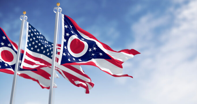 Ohio and national US flags waving in the wind on a clear day