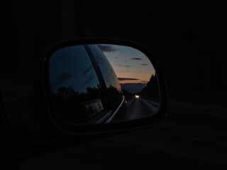 Sunset rearview road. Driving a car on a highway at dusk