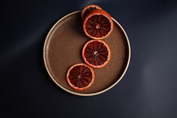 Sliced red orange on a brown plate
