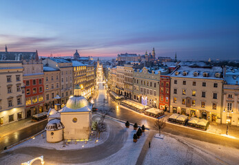 Main Square, St Adalbert church and Grodzka street illuminated in the night / dawn, Krakow, Poland