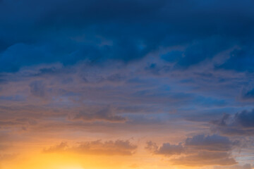 Dramatic Sunset Sky Background with Orange and Blue Clouds